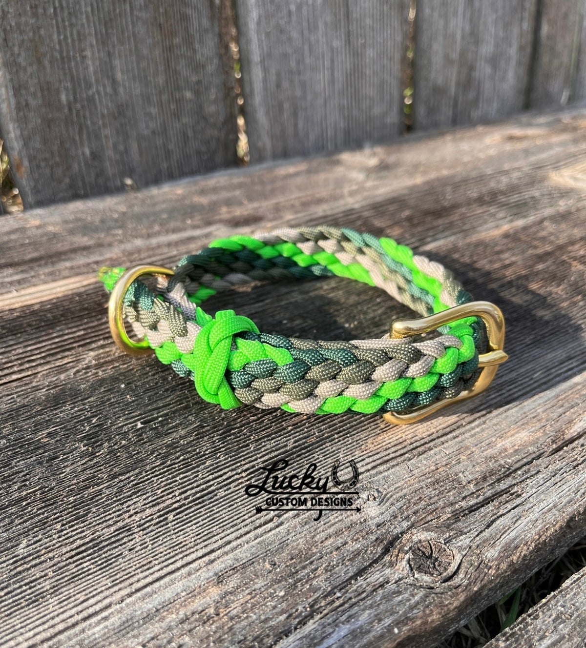 Braided dog collar with green and gray design on a wooden surface, featuring the brand 'Lucky U Custom Designs'.