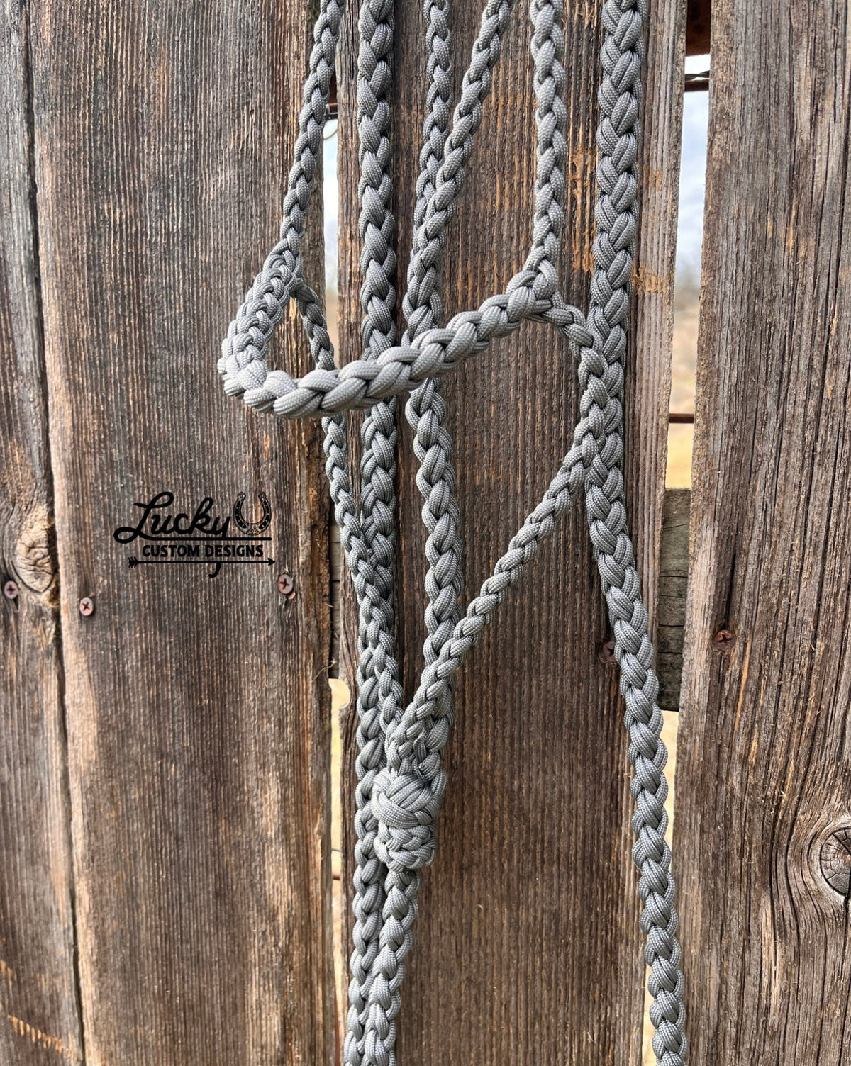 The paracord halter is built for cowboys & cowboy-gals who value quality & durability. 
Every halter is created from a continuous length of paracord. The cord is cut from the spool & never cut again during the braiding phase, resulting in a cleaner, stronger, & more dependable design. Each braid is extremely tight for strength and durability.
This is a one-of-a-kind design. 
