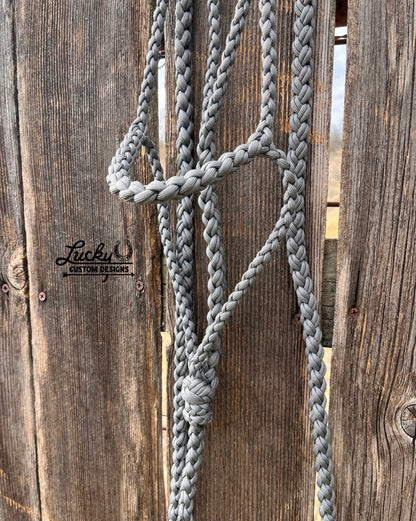 The paracord halter is built for cowboys & cowboy-gals who value quality & durability. 
Every halter is created from a continuous length of paracord. The cord is cut from the spool & never cut again during the braiding phase, resulting in a cleaner, stronger, & more dependable design. Each braid is extremely tight for strength and durability.
This is a one-of-a-kind design. 
